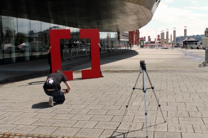 Cardiff School of Journalism student Toby Mott takes a picture of the Creative Cardiff big 'C's infront of Wales Millennium Centre